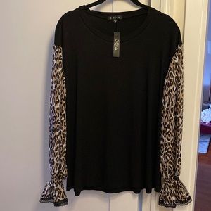 Knit top with chiffon sleeves and lace trim.
